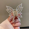 Butterfly-shaped alloy hair clip barrette for women, available in rhinestone or pearl style.