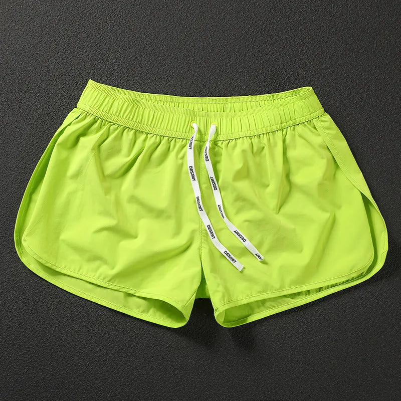 Men's loose fit polyester beach surfing shorts in fluorescent green with micro-elastic waistband