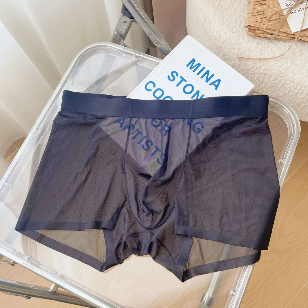 Men's thin seamless boxer shorts in black nylon fabric showing mid-waist and body-shaping design