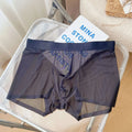 Men's thin seamless boxer shorts in black nylon fabric showing mid-waist and body-shaping design