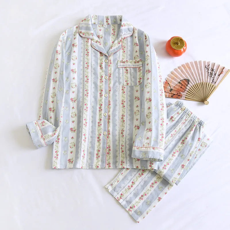 Women's red small fruit print cotton gauze long-sleeved pyjama top and trousers set laid flat.