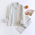 Women's red small fruit print cotton gauze long-sleeved pyjama top and trousers set laid flat.