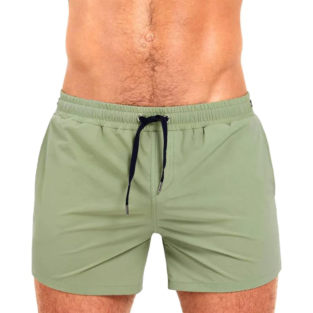 Mesh lining polyester sports shorts in army green, shown flat.