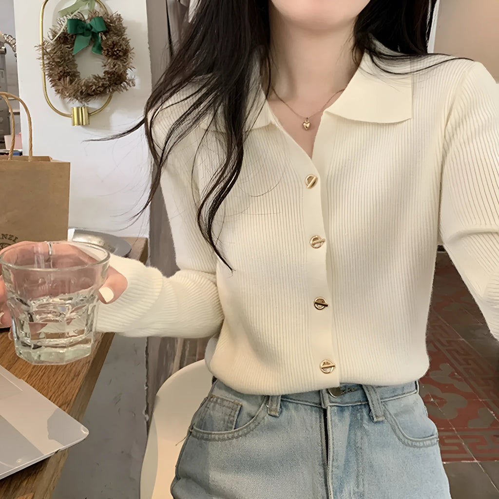 A loose-fitting, long-sleeved beige knitted cardigan for women, made from viscose fibre.