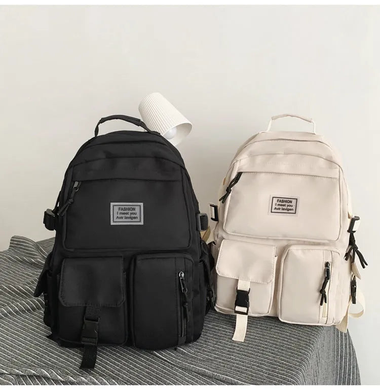 Soft nylon student backpack in black with a three-dimensional front pocket.