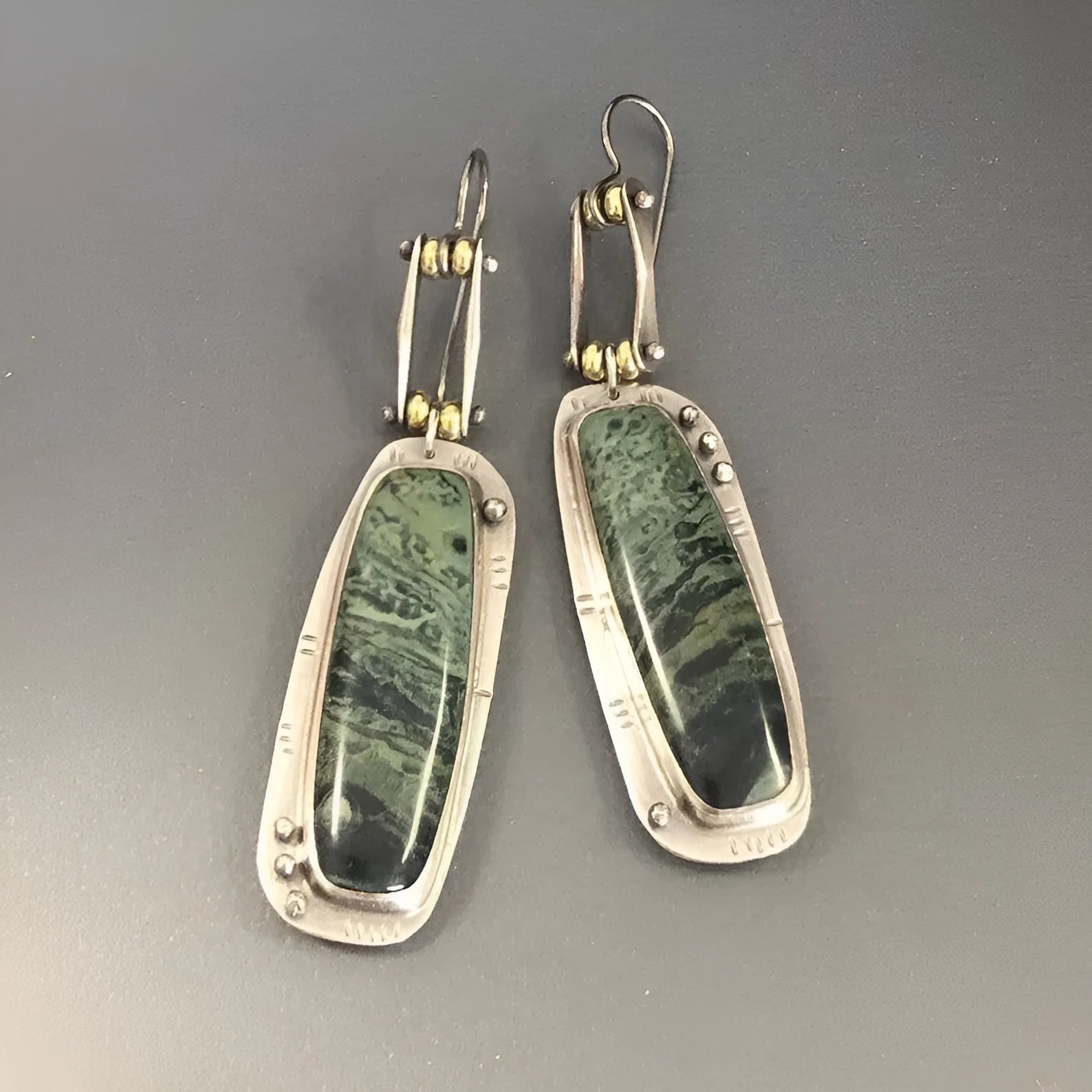 A pair of simple geometric alloy earrings with a two-tone marble pattern finish.