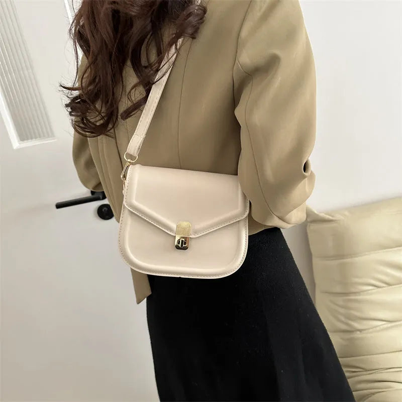 PU leather soft shell messenger bag with clamshell opening in a horizontal square shape.