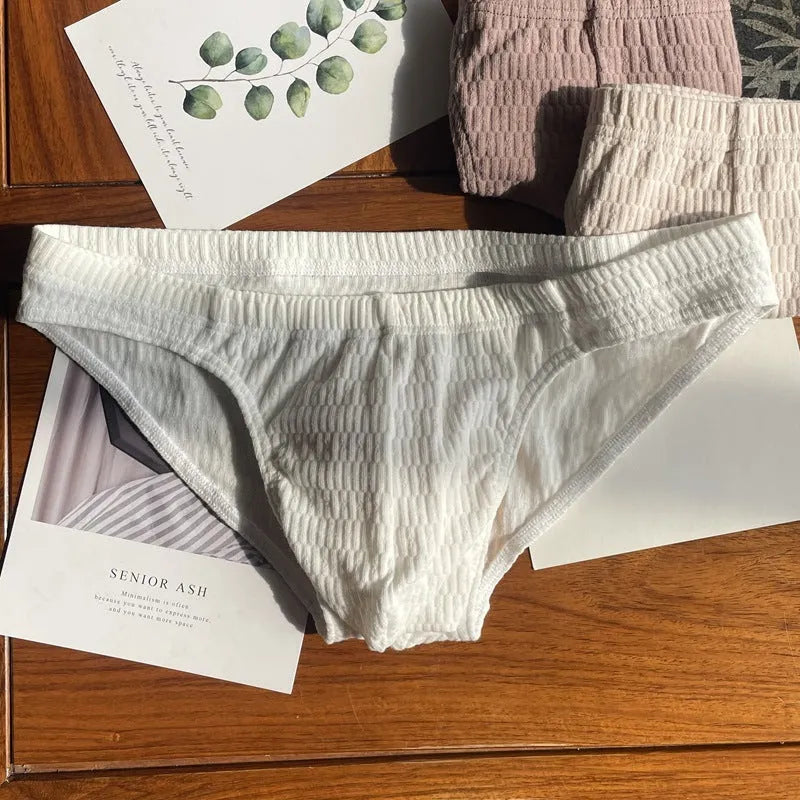 Men's solid colour pure cotton triangle underwear briefs in mid-waist style on a white background.