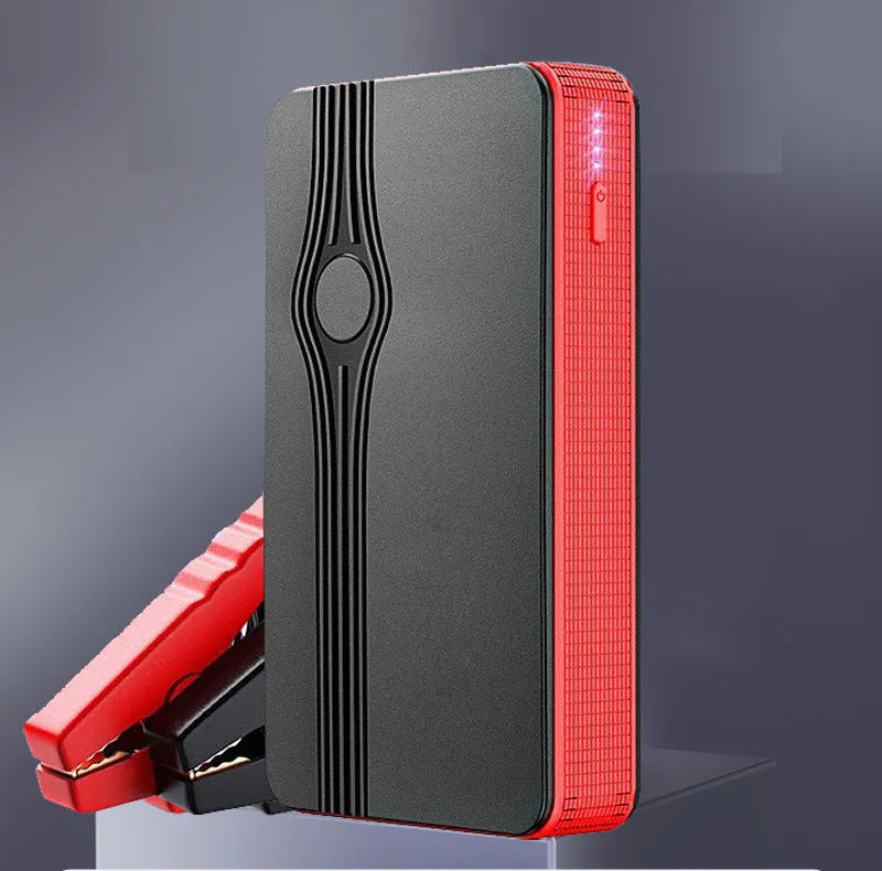 Red K4-E automobile emergency starting power supply unit with display, shown next to its included data cable.