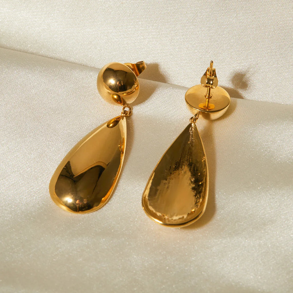 Gold electroplated stainless steel earrings with a geometric hemisphere and water drop pendant.