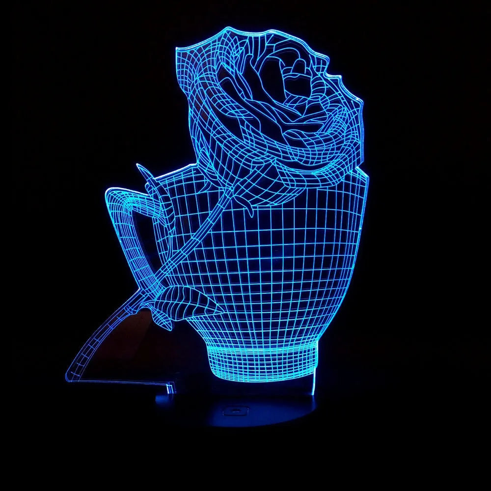 3D rose flower night light with colour-changing LED and remote control on a black base.