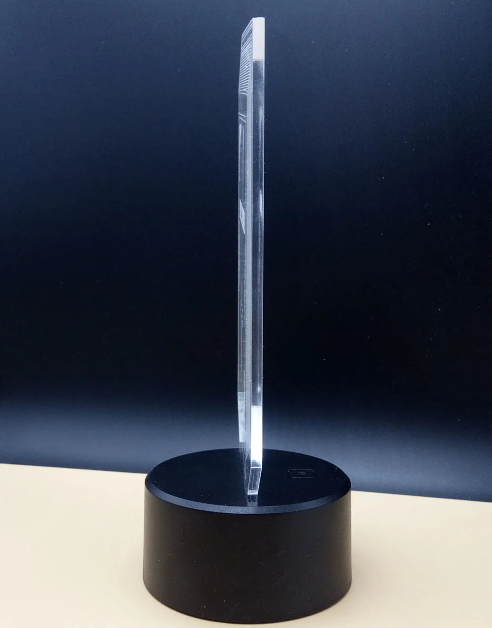 3D rose flower night light with colour-changing LED and remote control on a black base.