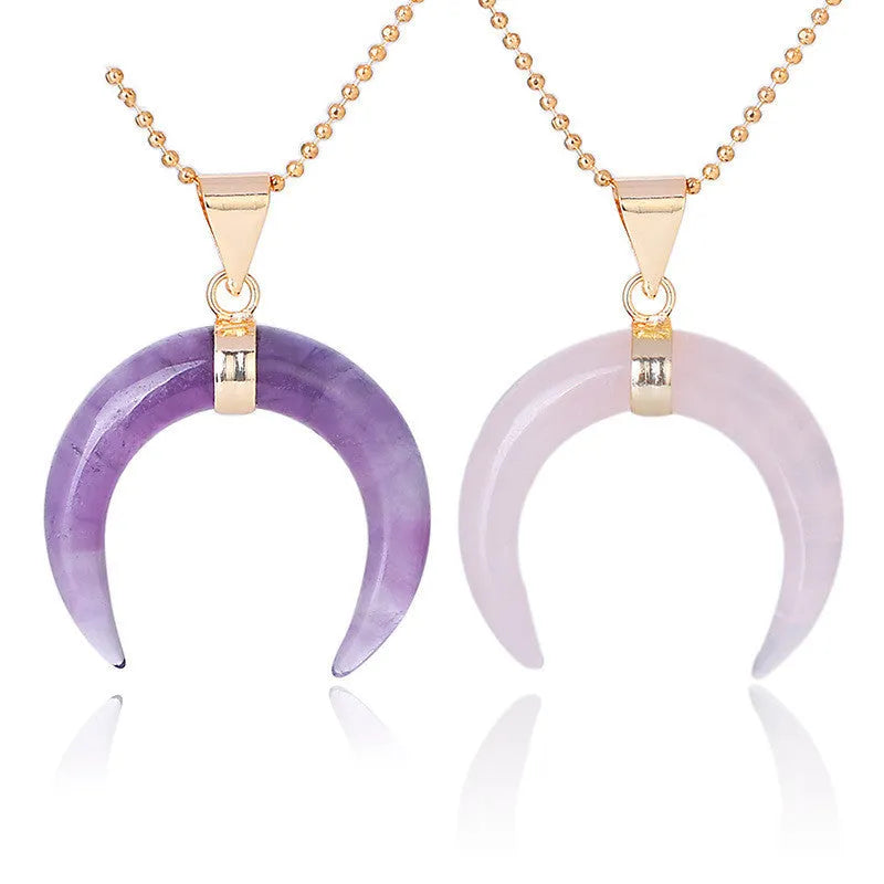 Close-up of a moon-shaped pendant necklace made from pink natural crystal stone on a 45cm electroplated copper chain.