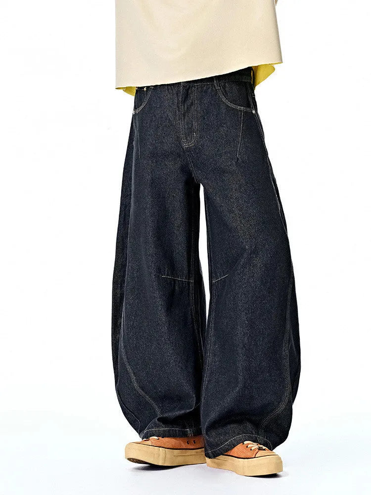Men's wide leg denim trousers in original cow colour, showing mid waist and relaxed fit.