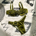 Women's green floral bikini swimsuit set with bra and briefs on a mannequin.