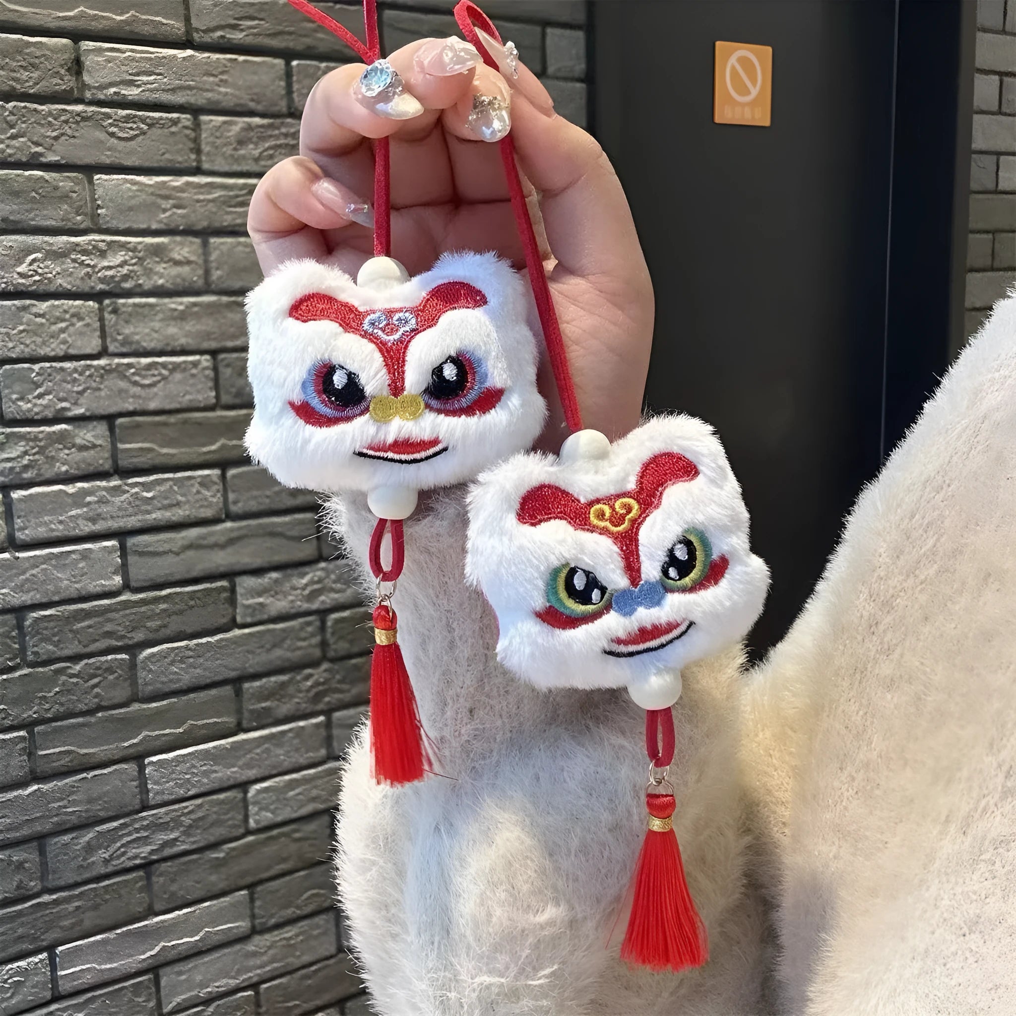 Blue and yellow Chinese style cartoon plush lion keychain ornaments with tassels and a star stone.