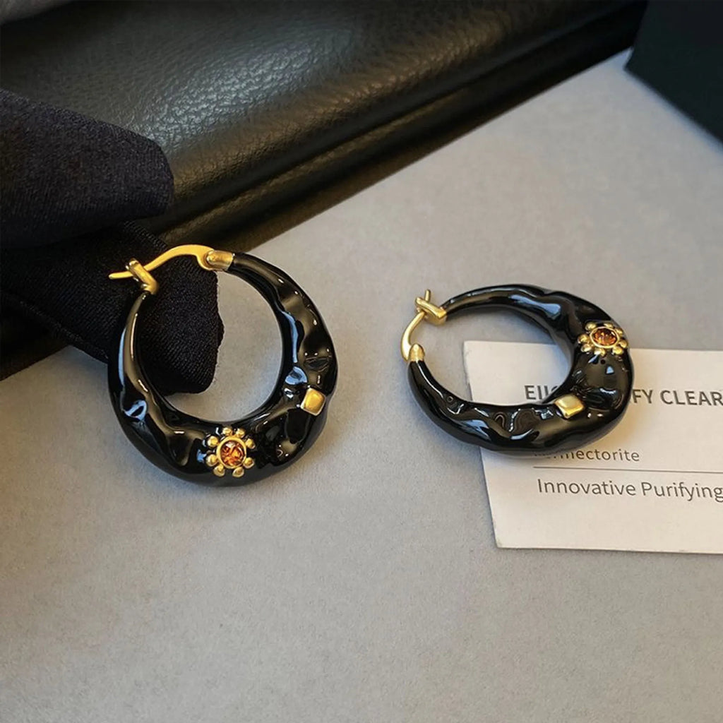 Hong Kong style retro ear studs with dripping oil finish and rhinestone accents in black and red colours
