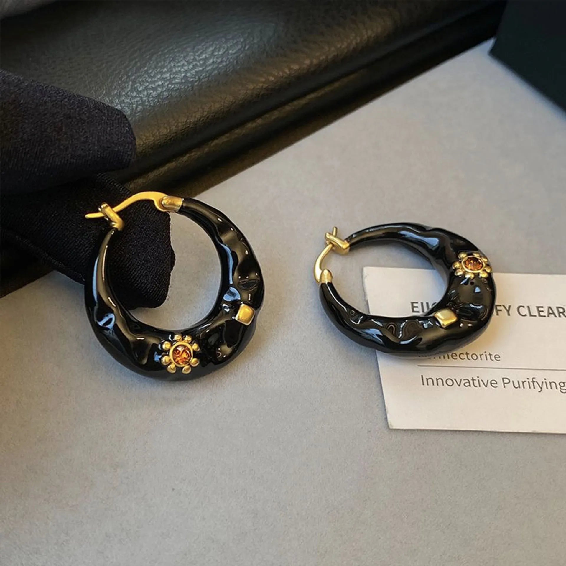 Hong Kong style retro ear studs with dripping oil finish and rhinestone accents in black and red colours