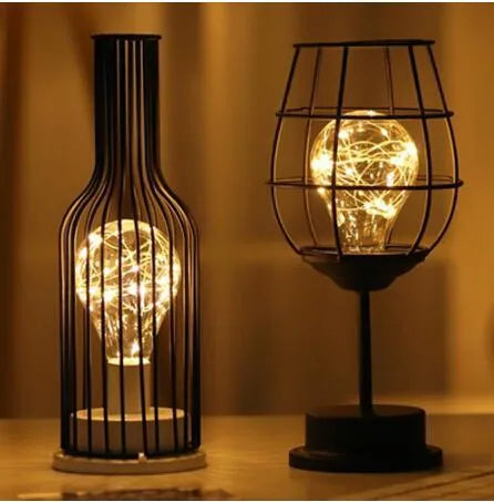 Minimalist hollow table lamp with wrought iron shell in red wine glass style emitting warm white LED light