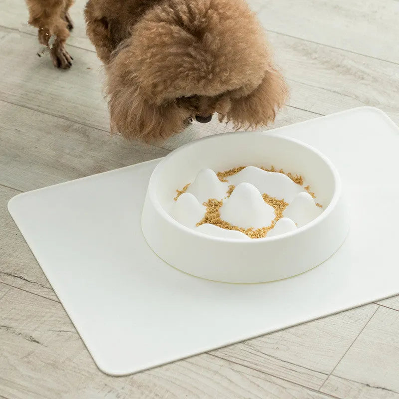 Pet slow food bowl with raised mountain bumps in off-white colour on a floor mat