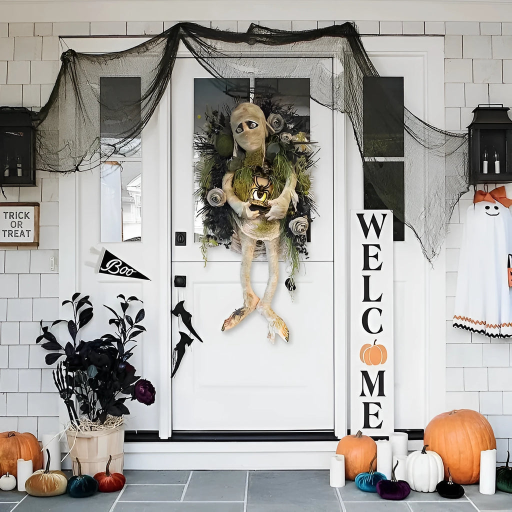 Three-dimensional mummy Halloween wreath with skeleton hands on a wooden door