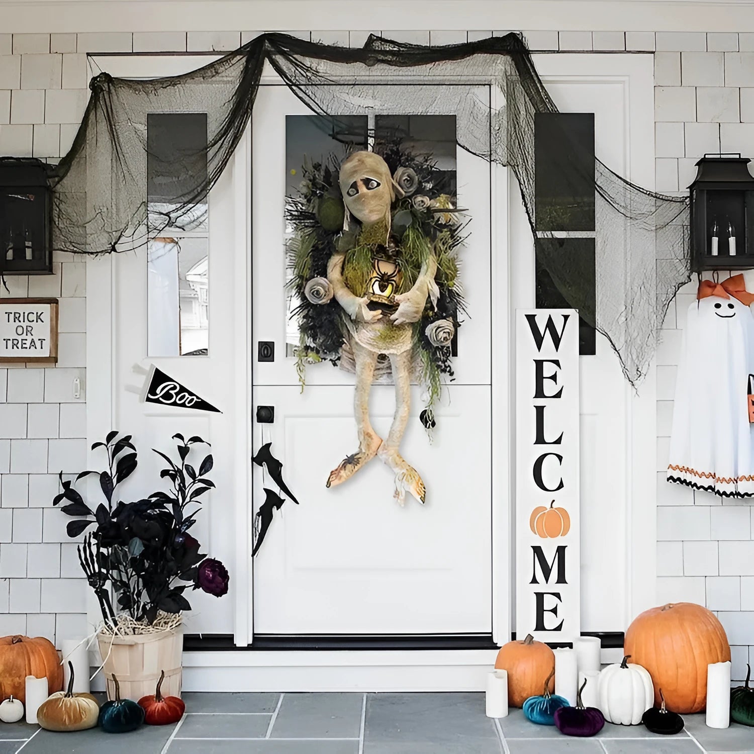Three-dimensional mummy Halloween wreath with skeleton hands on a wooden door