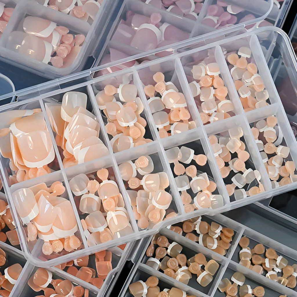 Box of 120 French manicure style nail pieces with white edges in nine nude colours, square short shape for toes.