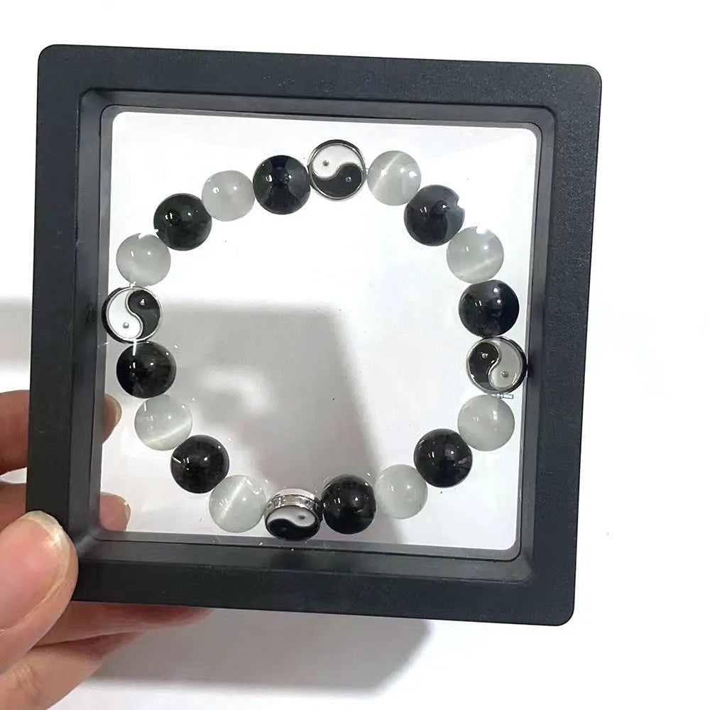 Natural stone opal agate Tai Chi bracelet with 10mm polished beads and black agate detail, unisex design on neutral background