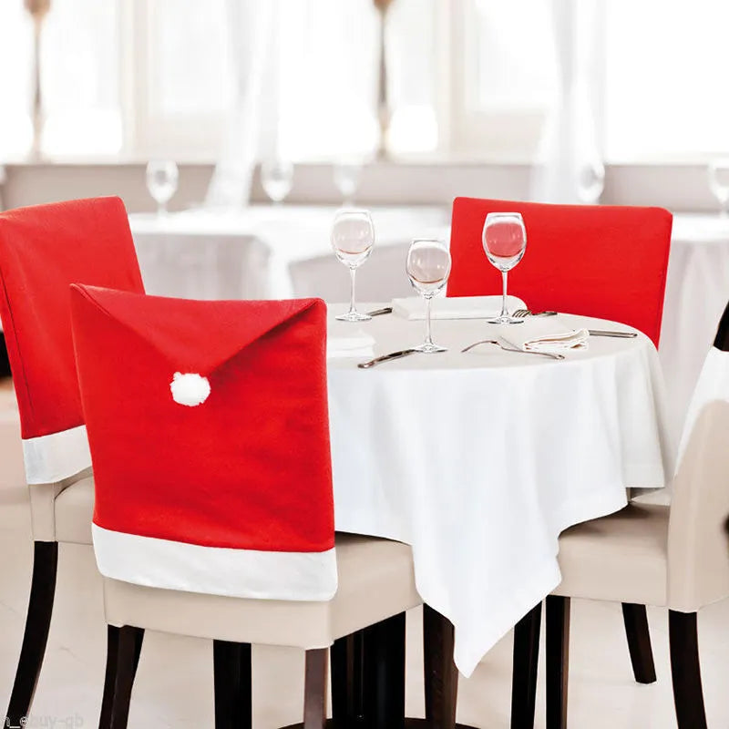 Christmas chair set with Santa Claus and Snowman covers and red Santa hat on standard dining chairs