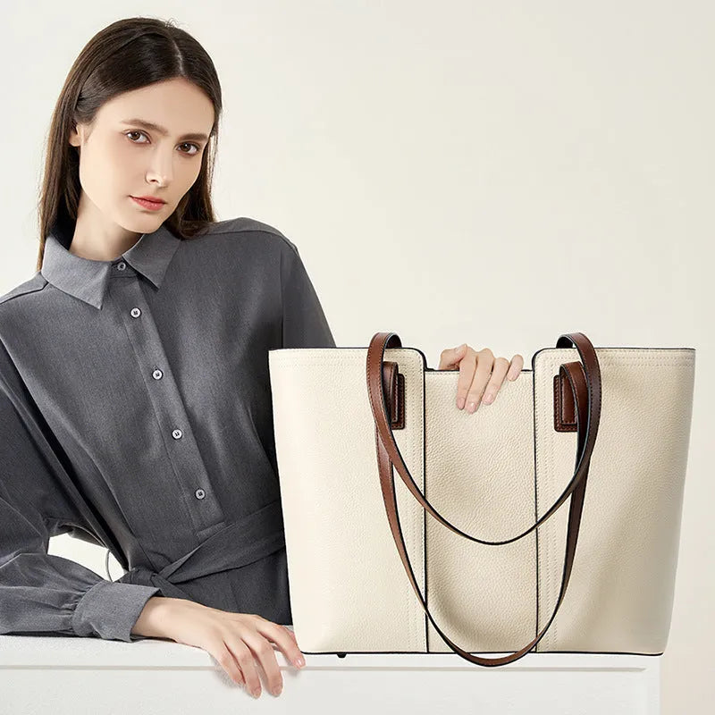 Women's black genuine cowhide leather commuter shoulder bag with horizontal square shape and multiple internal compartments