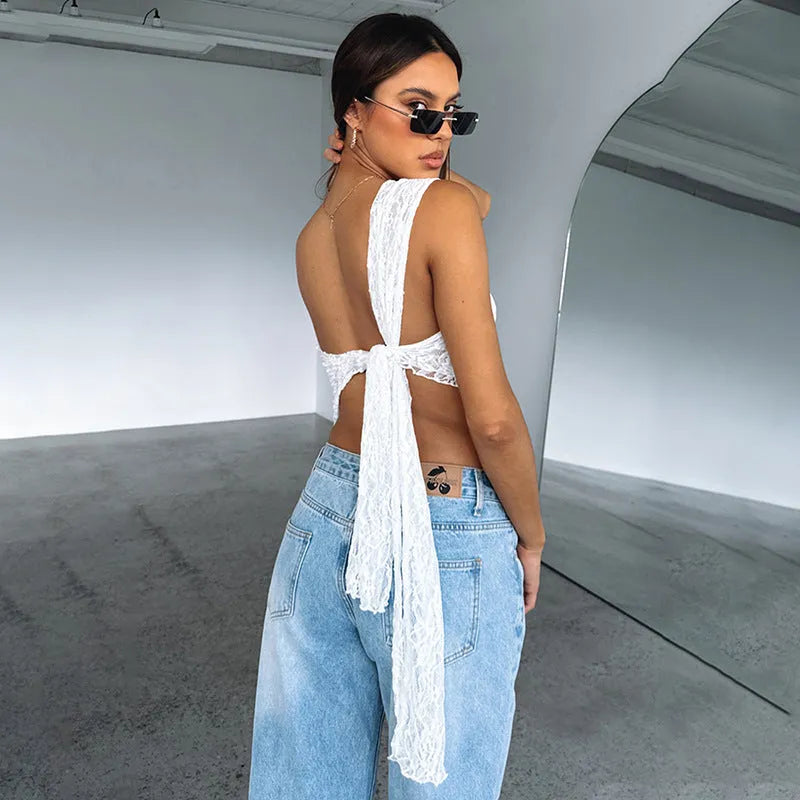 Women's sleeveless lace backless vest top with asymmetrical neckline in a solid colour.