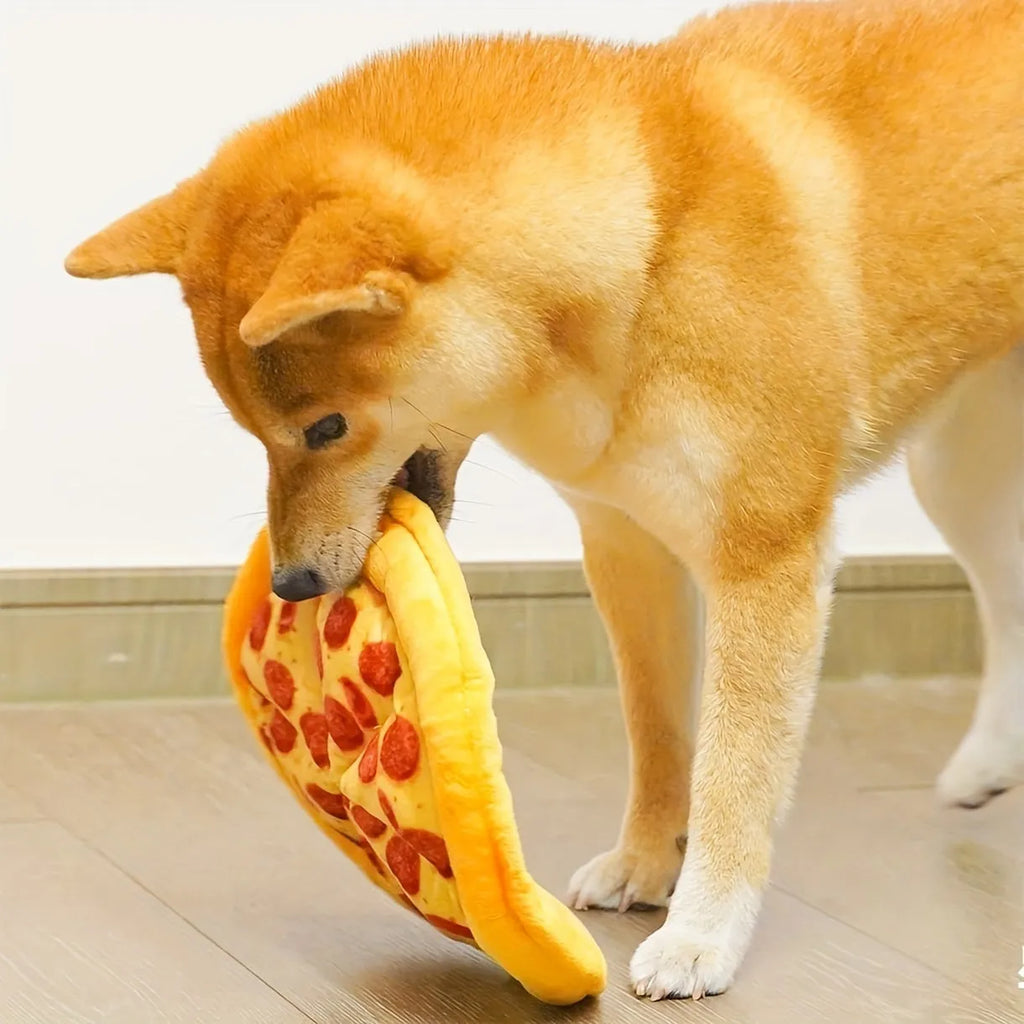 Yellow pizza slice dog chew toy with squeaker and dental grinding surfaces
