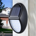 Black solar-powered wall light with automatic sensor for garden and outdoor security lighting