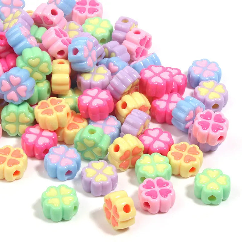 Assortment of 15mm frosted acrylic four-leaf clover beads in pink, yellow, green, blue, purple, and rose red.