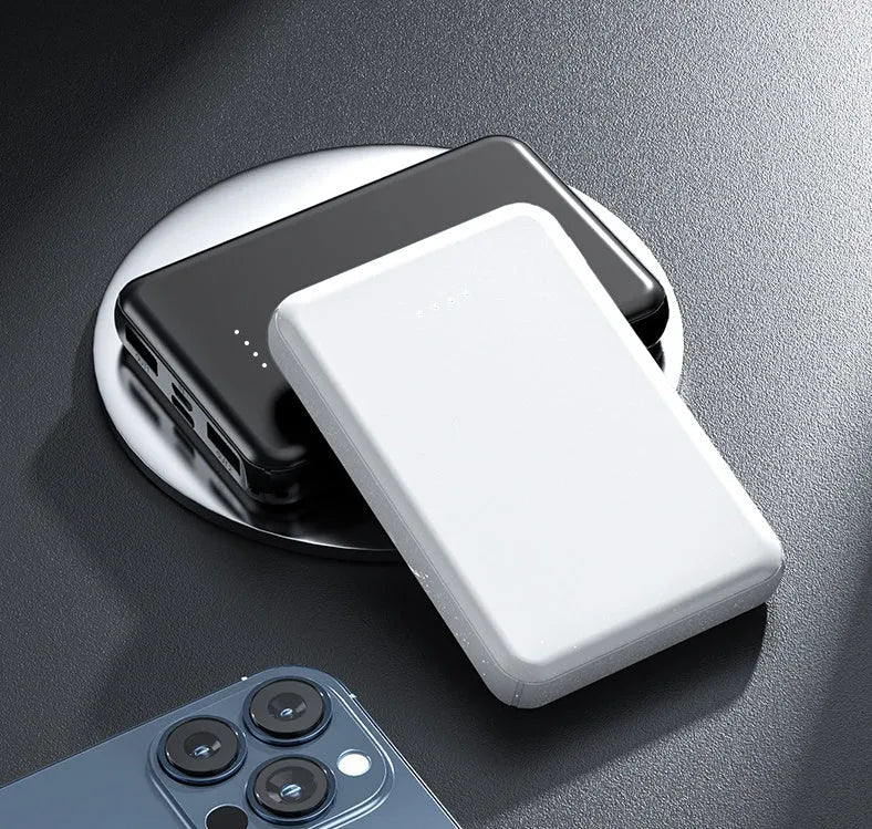 Black electric heating vest power bank with capacity display next to a white vest.
