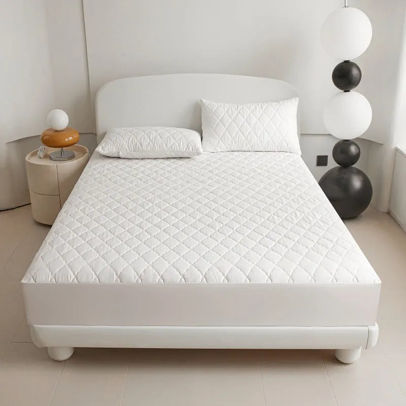 Diamond lattice quilted waterproof mattress protector in bamboo fibre, shown in a solid colour on a bed.
