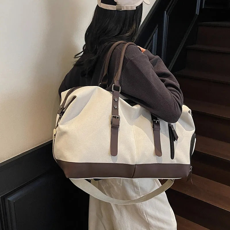 Canvas travel shoulder bag for men and women in solid black colour, breathable fabric, compact unisex design