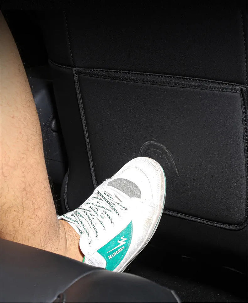 Black leather car seat kick pad measuring 68cm by 42cm, shown as a rear seat protector.