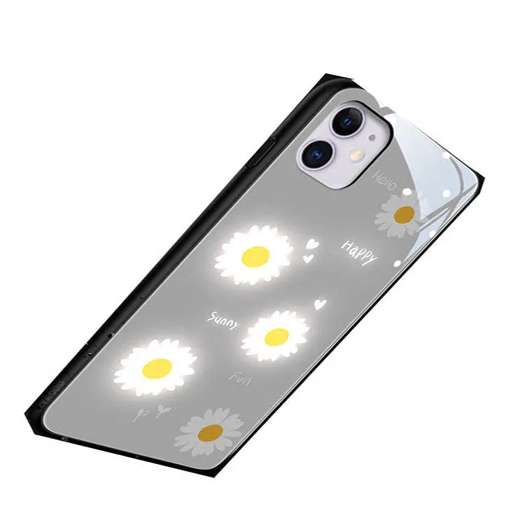 White Apple iPhone case with painted daisy pattern and illuminated voice-activated colour light on display.