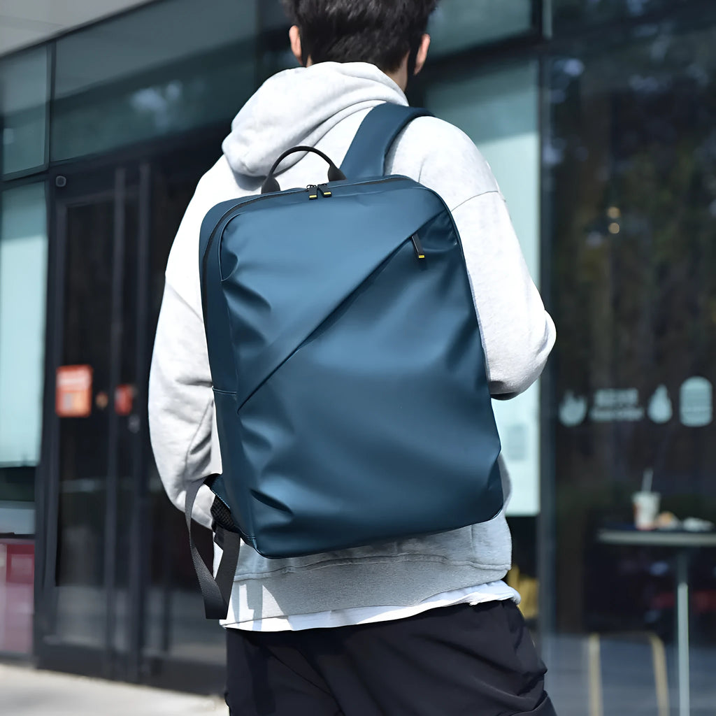 Waterproof PU leather men's backpack in black, blue and grey colour options showing large capacity design