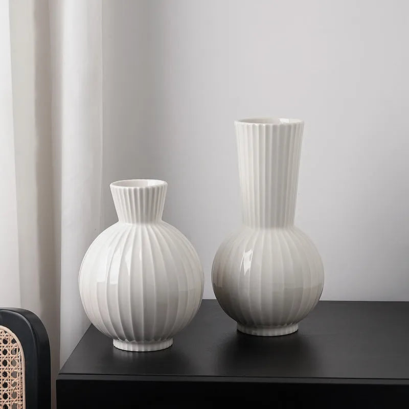 White ceramic ball vase with stripes, American country style, shown on a table.