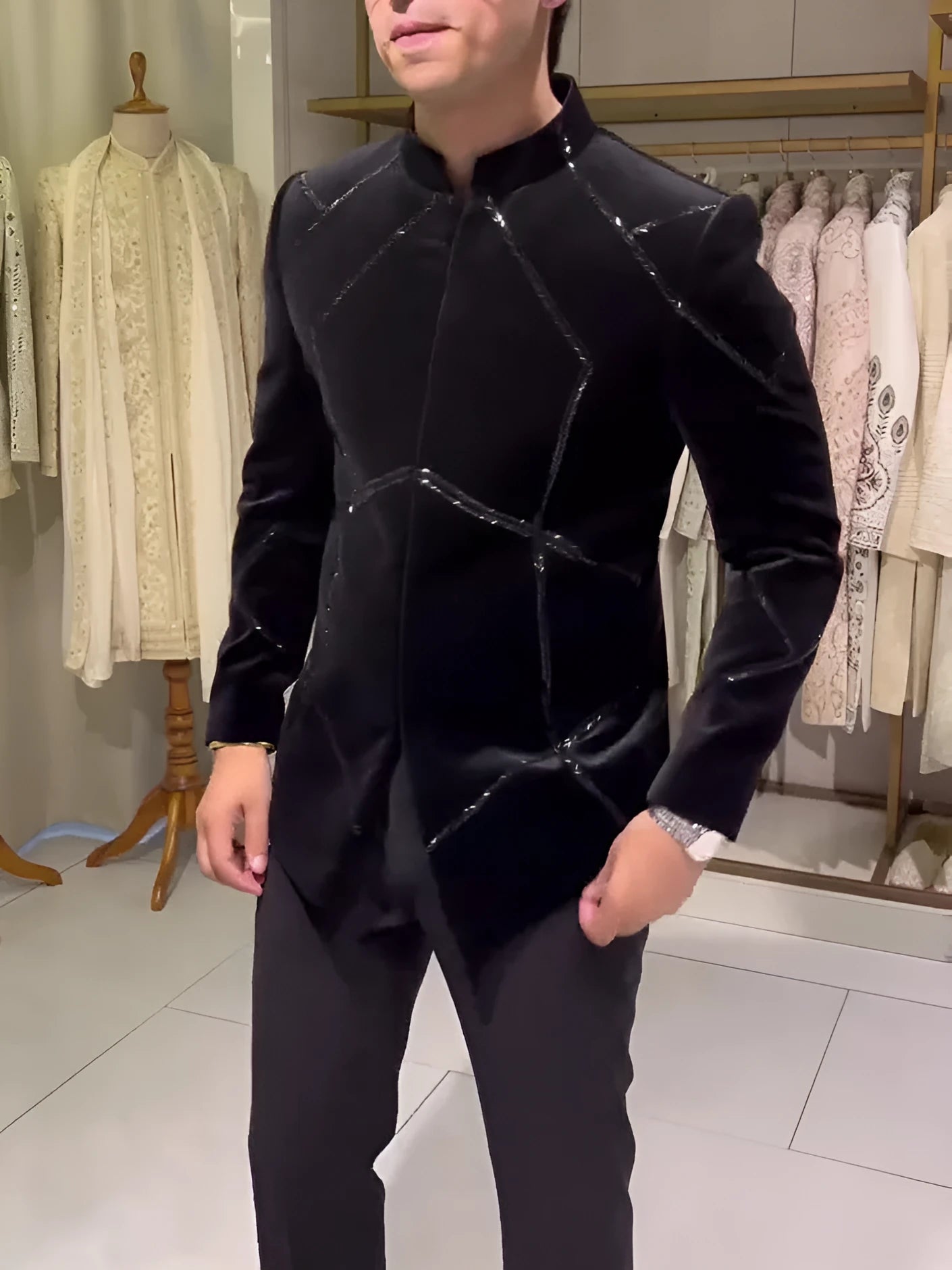 Black structured jacket with contrast geometric patchwork accents, regular fit, front view