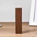 Portable black walnut solid wood power bank with 2000mAh 18650 battery, 100mm length, brown colour, on light background
