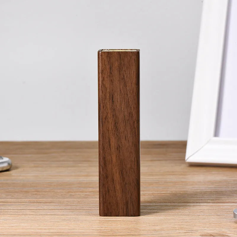 Portable black walnut solid wood power bank with 2000mAh 18650 battery, 100mm length, brown colour, on light background