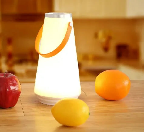 White rechargeable LED night light lantern on bedside table measuring 12x12x22cm with warm light