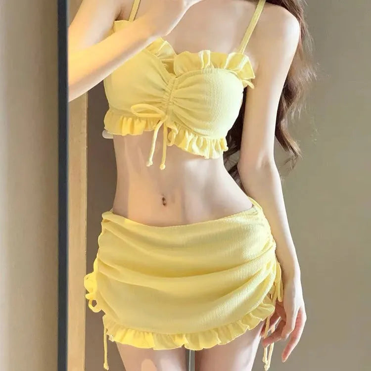 Women's milk silk split bikini swimsuit in solid colour, shown in pitaya red, yellow, or black.
