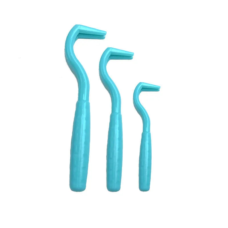 Set of three coloured plastic tick hook removal tools for dogs on a white background