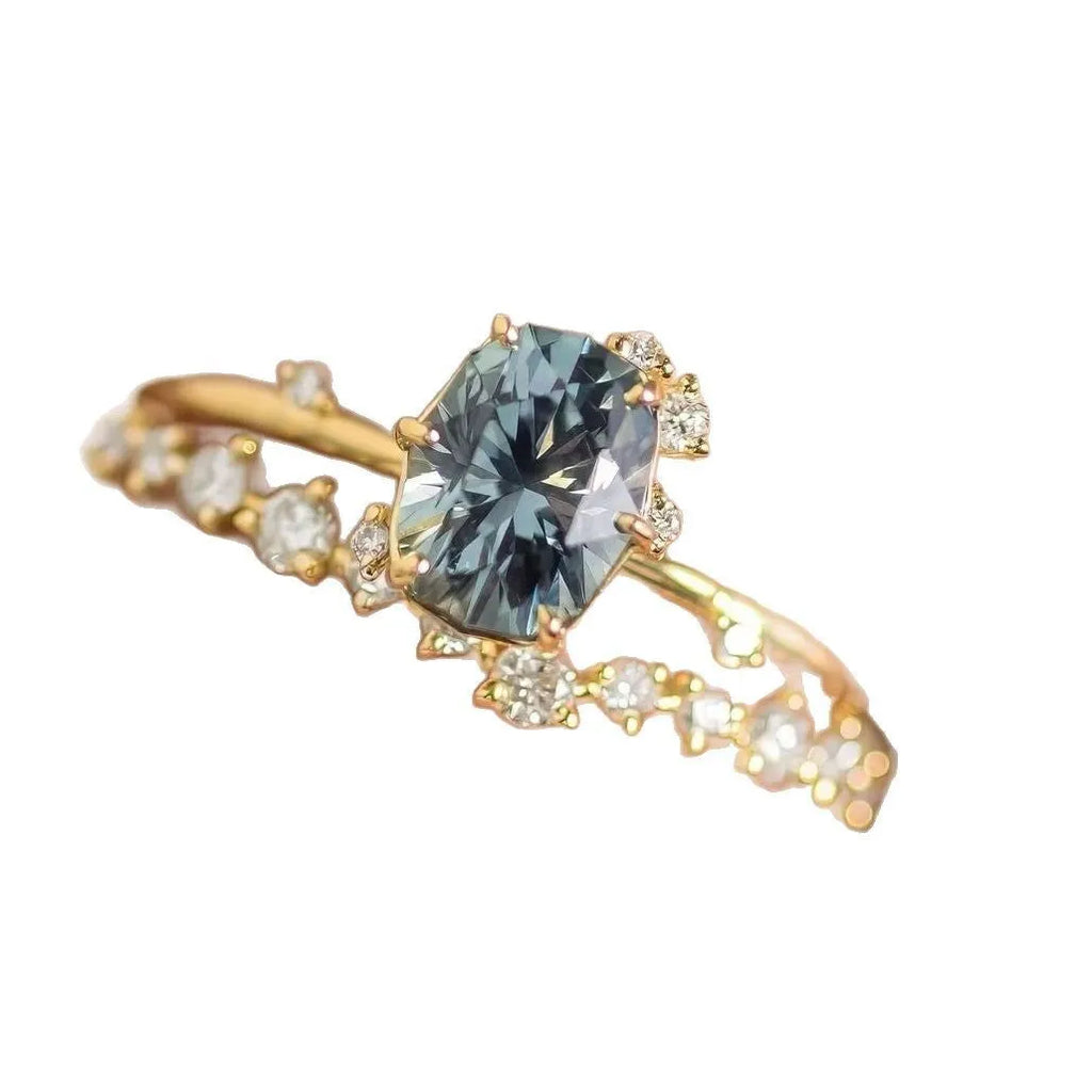 Gold plated alloy ring with floral design and green zircon stone, shown in various sizes