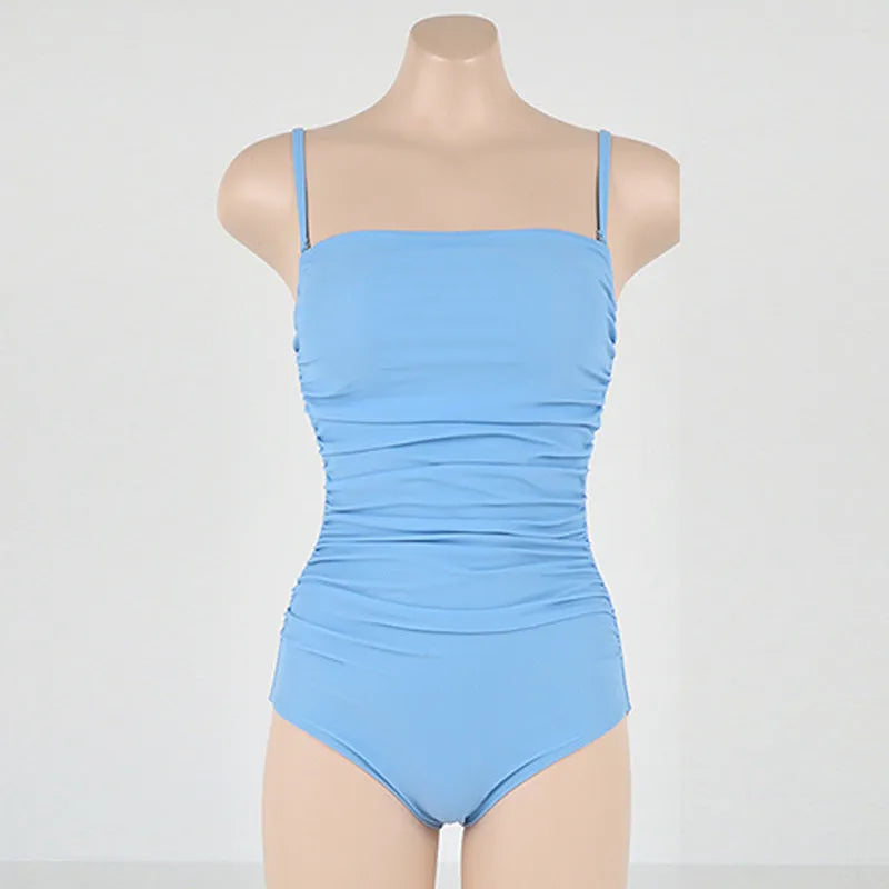 Sling style one-piece swimsuit with belly pleats in solid colour options