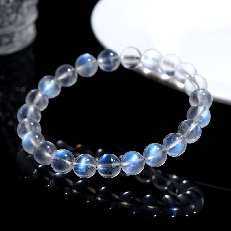Natural cream body blue moonlight crystal bracelet with matte finish on a wrist.